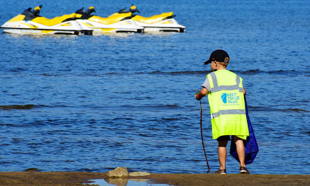 Young volunteer cleaning up at Keep Tahoe Red White and Blue event