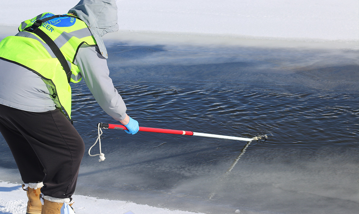 A citizen scientist samples water quality